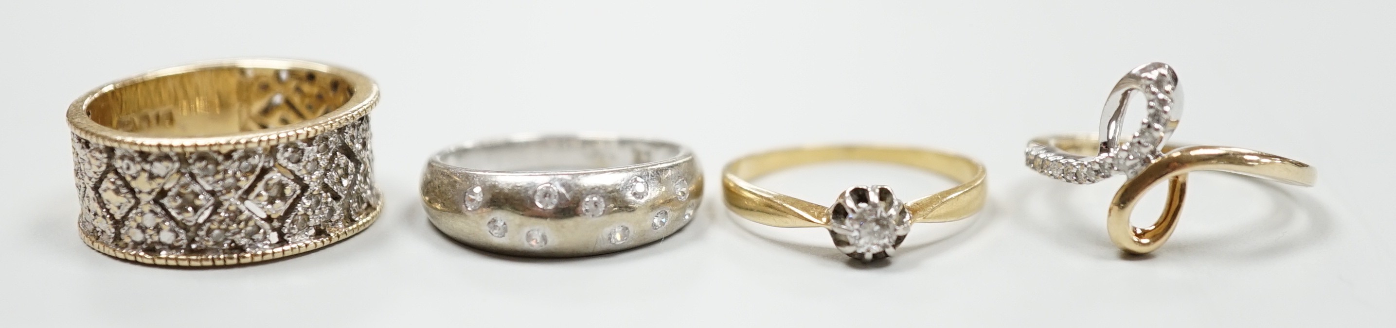 Three modern 9ct gold and diamond chip set rings and a yellow metal and solitaire diamond set ring, gross weight 12.4 grams.